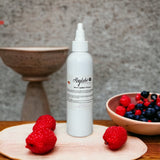 Sérum capillaire à la fraise pour hydratation intense, idéal pour la brillance et la pousse des cheveux crépus.